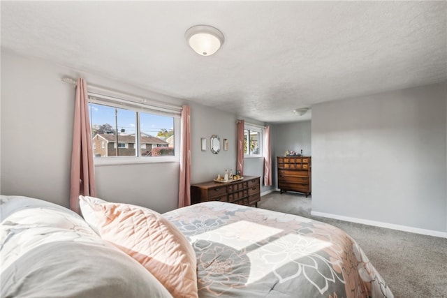 bedroom featuring light carpet and a textured ceiling