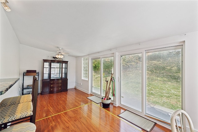 interior space with ceiling fan