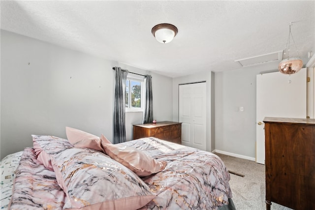 bedroom with a closet, carpet, and a textured ceiling