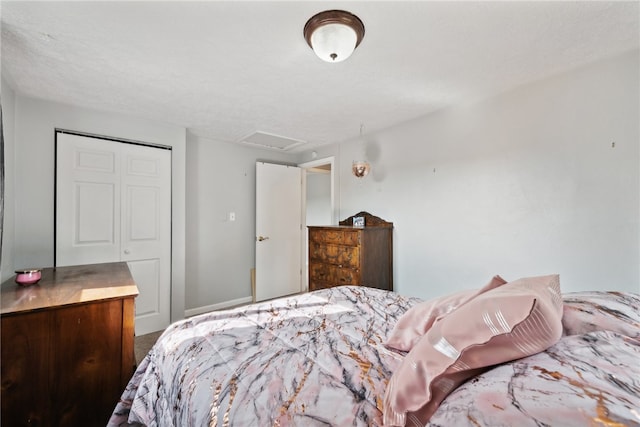 bedroom with a textured ceiling and a closet