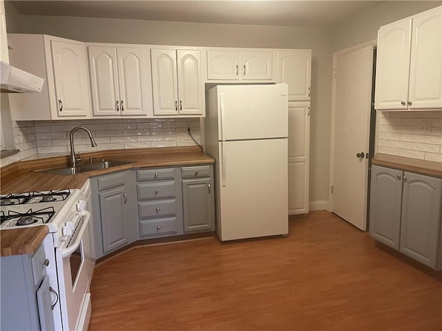 kitchen featuring white cabinetry and white appliances