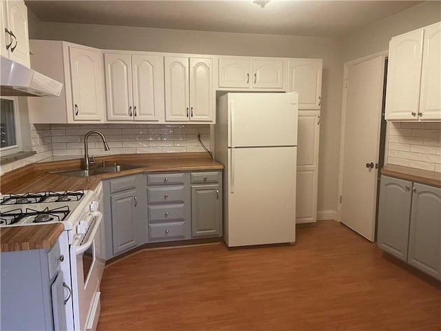 kitchen with white appliances, sink, gray cabinets, white cabinetry, and butcher block counters