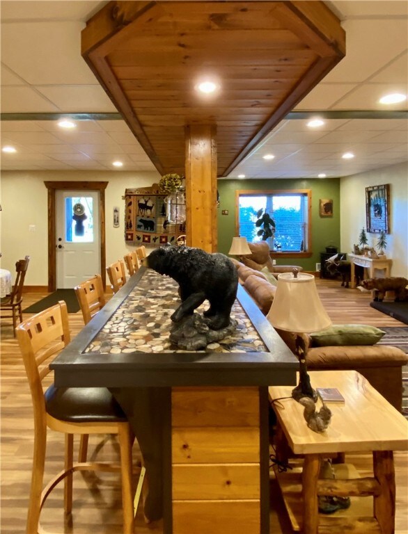 bar with hardwood / wood-style floors and plenty of natural light