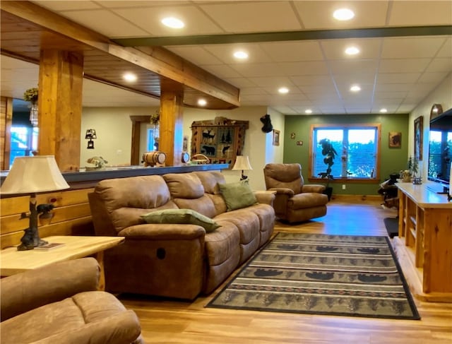 home theater room featuring a drop ceiling and wood-type flooring