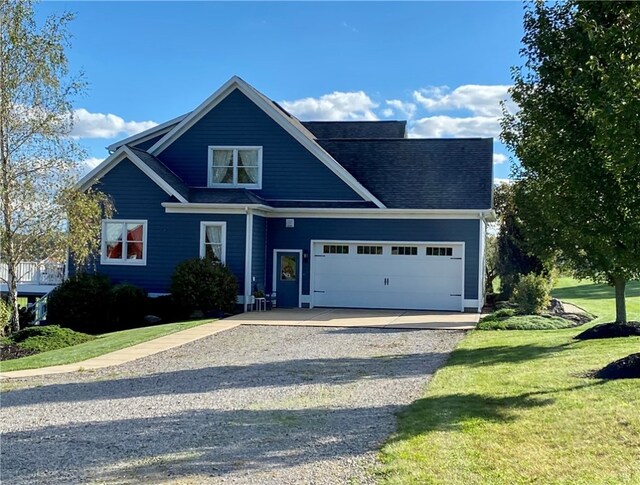 view of front of property featuring a front yard and a garage