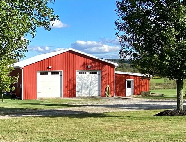 exterior space with a garage and a lawn