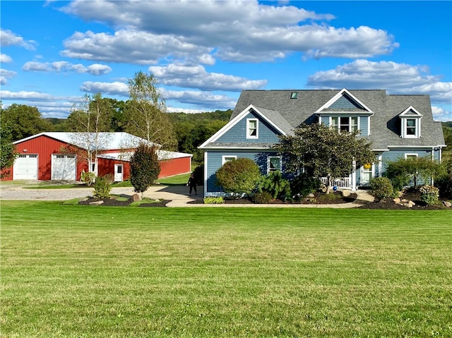 view of front of home featuring an outdoor structure, a front yard, and a garage