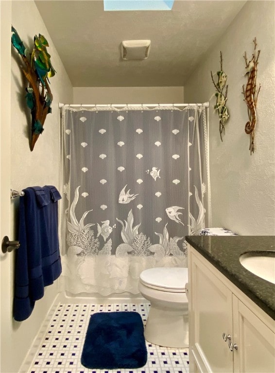 bathroom featuring vanity, a shower with curtain, toilet, and tile patterned flooring