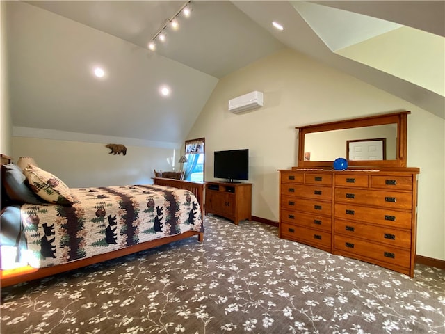 carpeted bedroom with track lighting, vaulted ceiling, and a wall unit AC