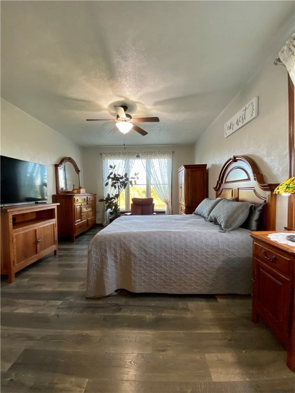 bedroom featuring dark hardwood / wood-style flooring and ceiling fan