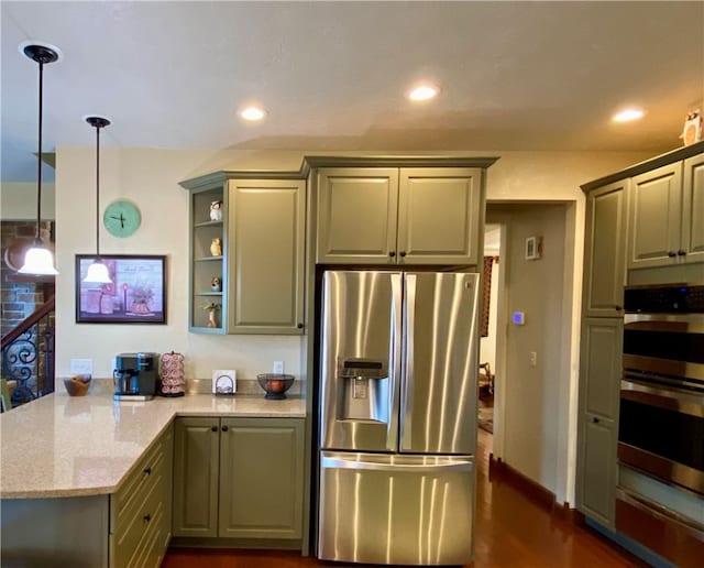 kitchen featuring light stone countertops, decorative light fixtures, stainless steel appliances, and dark hardwood / wood-style flooring