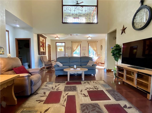 living room with a high ceiling and ceiling fan