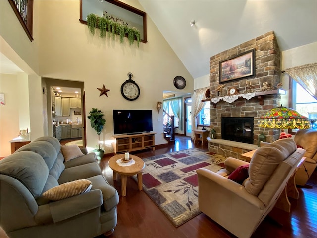 living room featuring high vaulted ceiling, a fireplace, and dark hardwood / wood-style floors