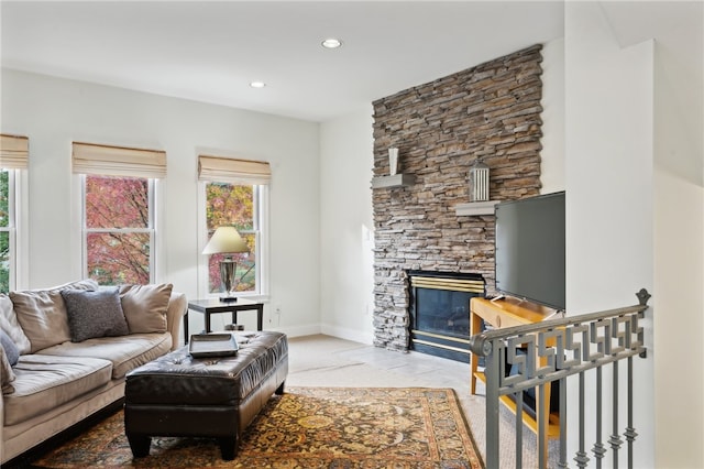 carpeted living room with a fireplace and a healthy amount of sunlight