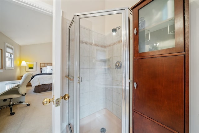 bathroom with a shower with door