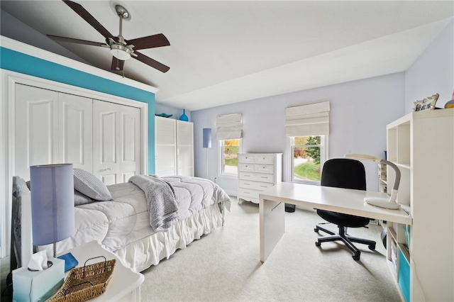 bedroom featuring a closet, ceiling fan, carpet flooring, and lofted ceiling