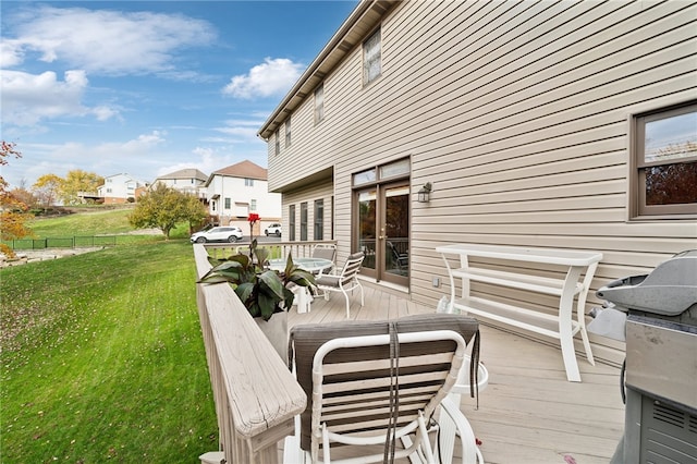 wooden deck with a lawn