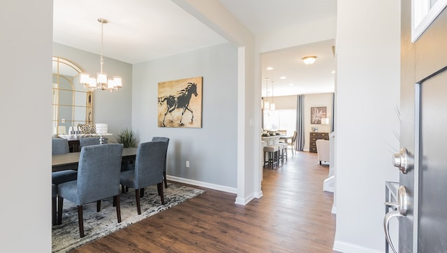 dining area featuring a chandelier, recessed lighting, dark wood finished floors, and baseboards