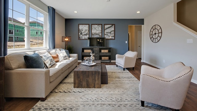 living room with a fireplace, baseboards, wood finished floors, and recessed lighting