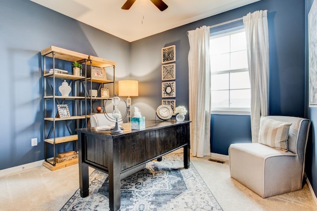 office area with baseboards, a ceiling fan, and light colored carpet