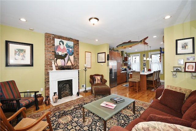 living room featuring a fireplace and light hardwood / wood-style floors