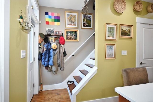 stairs featuring hardwood / wood-style floors