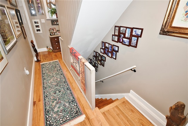 stairway featuring wood-type flooring