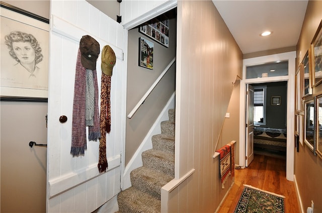 stairs featuring wood-type flooring