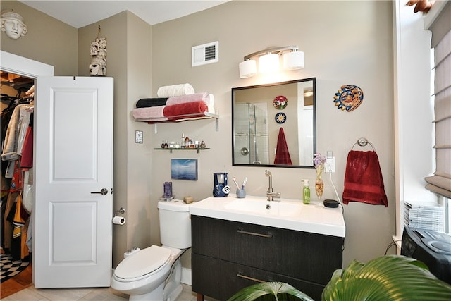 bathroom with vanity, toilet, and a shower with shower door