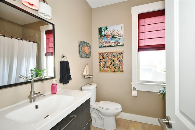 bathroom featuring vanity, wood-type flooring, and toilet