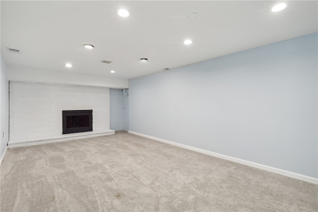 unfurnished living room featuring light carpet and a fireplace