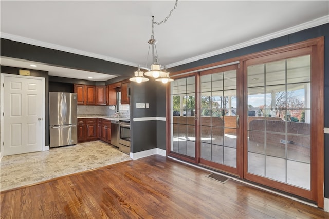 kitchen featuring light hardwood / wood-style floors, tasteful backsplash, and stainless steel appliances