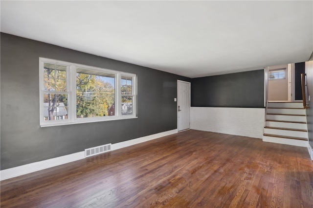 unfurnished room with dark wood-type flooring