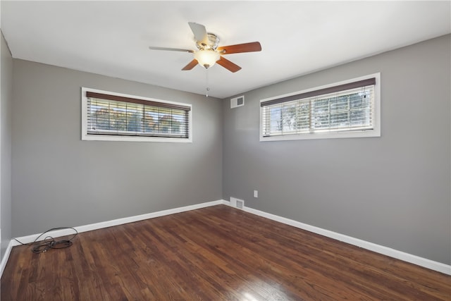 spare room with hardwood / wood-style floors, ceiling fan, and a wealth of natural light