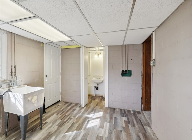 interior space featuring wood-type flooring and a paneled ceiling