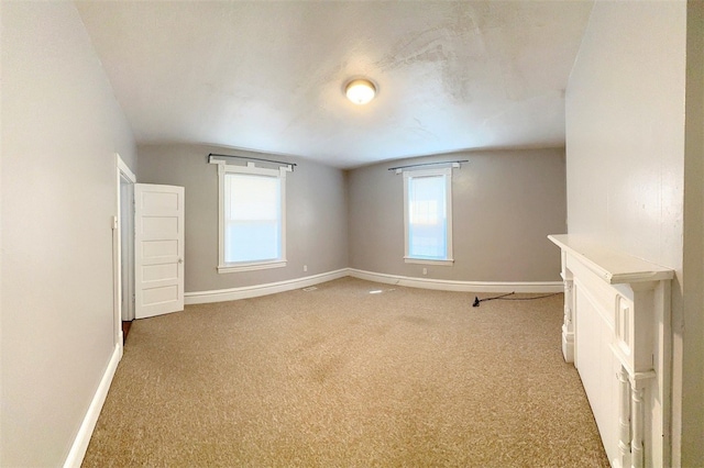 carpeted empty room featuring plenty of natural light