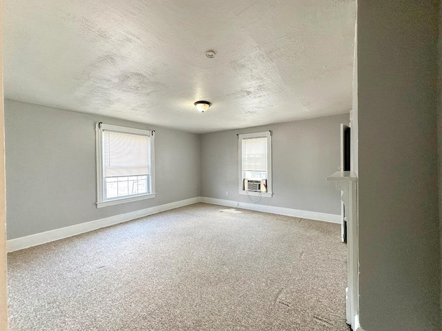 carpeted empty room featuring a healthy amount of sunlight and a textured ceiling