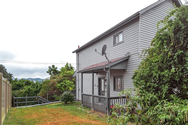 view of side of home with a lawn