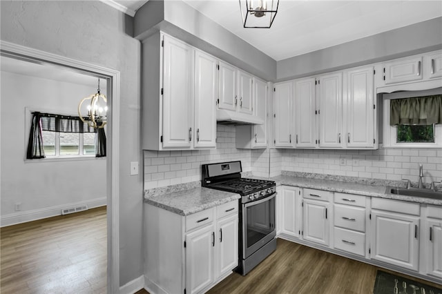 kitchen featuring white cabinets, dark hardwood / wood-style flooring, sink, and stainless steel gas range oven