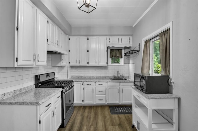 kitchen featuring backsplash, dark hardwood / wood-style flooring, white cabinets, ornamental molding, and stainless steel gas range