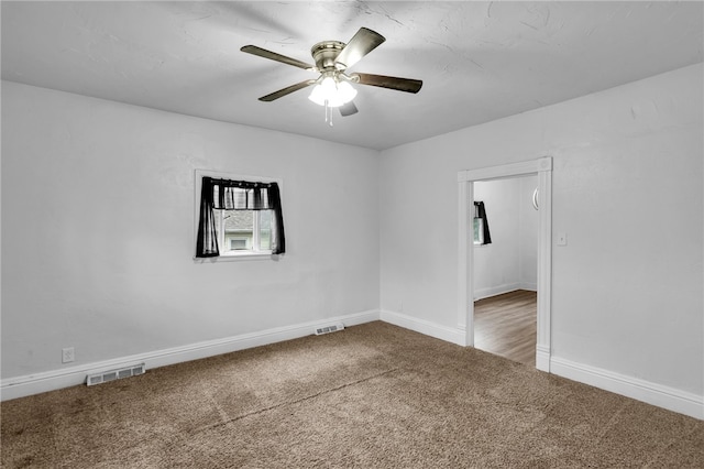 carpeted empty room featuring ceiling fan