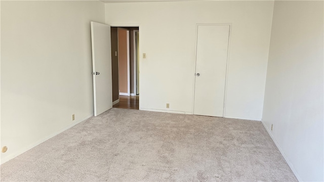 unfurnished bedroom with light colored carpet