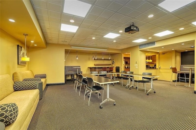 interior space with a drop ceiling and carpet