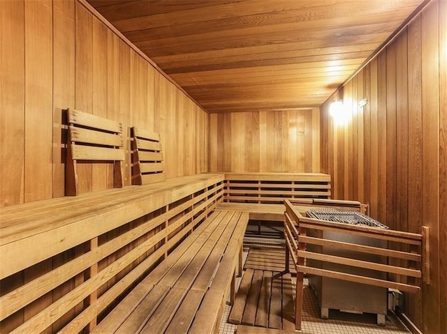 view of sauna featuring wooden walls and wooden ceiling