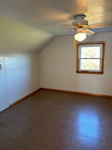 additional living space featuring ceiling fan and vaulted ceiling