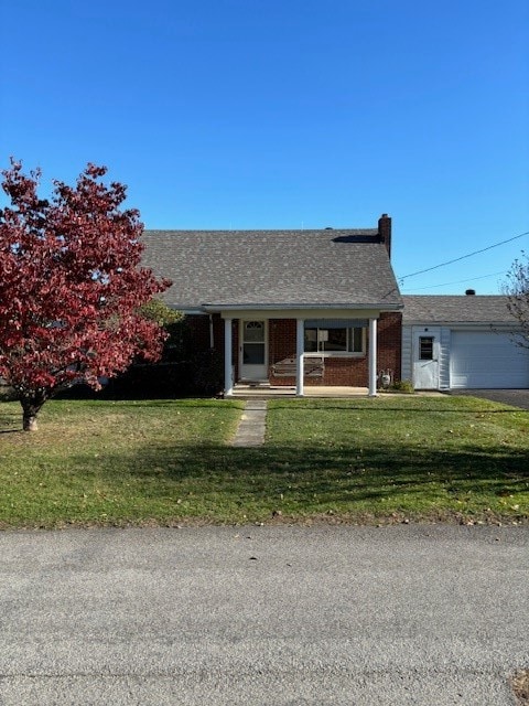 ranch-style house featuring a front yard, a porch, and a garage