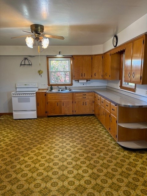 kitchen featuring sink, electric range, and ceiling fan