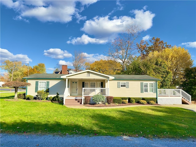 view of front of property with covered porch and a front yard