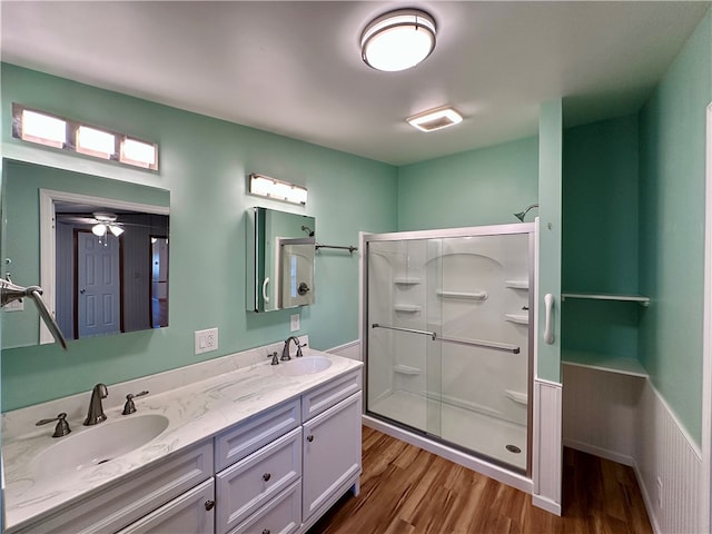 bathroom with vanity, ceiling fan, wood-type flooring, and an enclosed shower