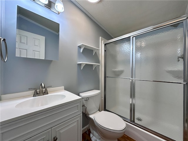 bathroom featuring a shower with door, toilet, ornamental molding, vanity, and a textured ceiling